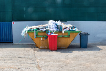  recycle paper separation in the metal bin outdoors in front of the warehouse - obrazy, fototapety, plakaty