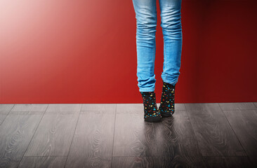 Fashion, jeans and legs of woman in studio with stylish clothes standing on red background. Trendy,...