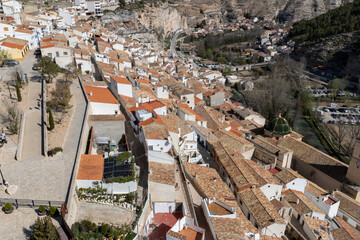Panoramic view of the town of Alcalá del júcar. Popular cave houses, carved into the mountain,...