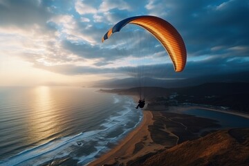 paraglider flies over the seashore, beautiful light