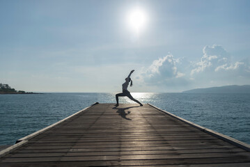 Young woman practicing yoga during yoga retreat in Asia, relaxation, exercise