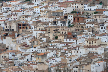 Naklejka premium Panoramic view of the town of Alcalá del jucar from Las Eras viewpoint. Its popular cave houses, carved into the mountain, the castle and Church of San Andrés in the gorge of the jucar river, Albacete