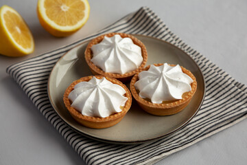 Homemade Lemon Tartlets on a Plate, side view.