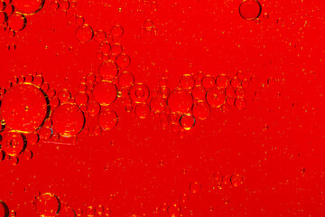 Macro red soft drink background,abstract background. drops of oil on water, red and green color....