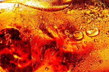 Macro cola drink background,Close up view of ice cubes in dark cola background. Surface of sweet...