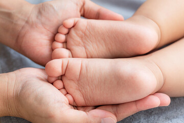 Baby feet close up,A close-up of tiny baby feet,Baby feet on white coverlet. Toes. Feet how a heart...