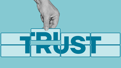 Building trust in business concept. Building a structure of blocks with the word trust