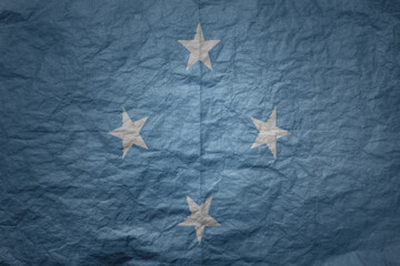 big national flag of Federated States of Micronesia on a grunge old paper texture background - obrazy, fototapety, plakaty