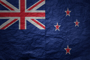 big national flag of new zealand on a grunge old paper texture background