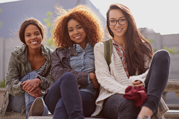Portrait, female learners and friends of campus, break and relax for classes at university. Face, happy and diversity at school and education for women student, academics and learning at college