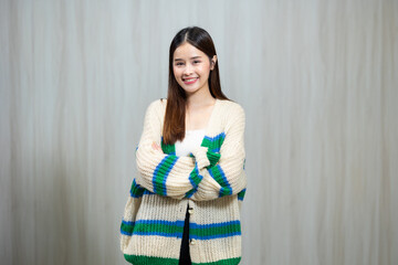 Portrait People lifestyle concept - Asian young woman in white and green winter knitted sweater shirt standing wood wall background