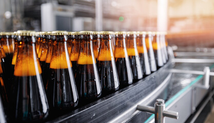 Brown glass beer drink alcohol bottles, brewery conveyor, modern industrial food production line...