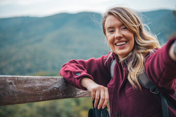 Young woman taking selfie portrait hiking mountains - Happy hiker on the top of the cliff smiling at camera - Travel and hobby concept.  Travel and active lifestyle concept. - 786266041