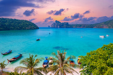 Island Phi Phi with longtail boat, turquoise clear water in Krabi Thailand. Amazing travel landscape photo in Thai
