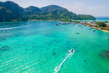 Island Phi Phi with longtail boat, turquoise clear water in Krabi Thailand. Amazing travel landscape photo in Thai