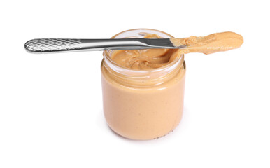 Tasty nut paste in jar and knife isolated on white