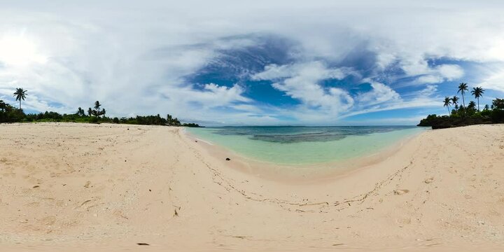 Ocean waves on sandy beach. Blue sky and clouds. Carabao Island in Romblon, Philippines. VR 360.
