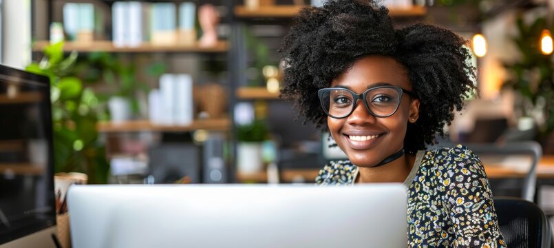 Smiling hiring manager interviewing job candidate in a welcoming office environment