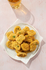 Plate of chicken nuggets on table, fast food dish