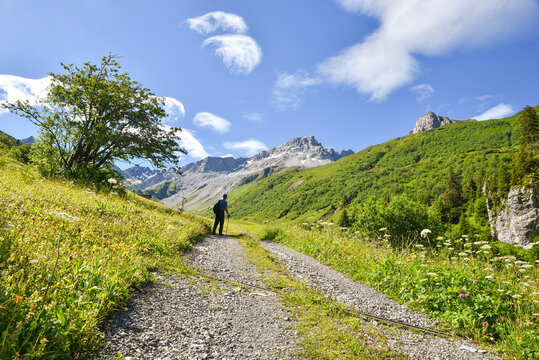 hiker at walkway Gafiertal valley, idyllic alpine landscape Prattigau, switzerland