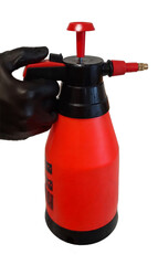 Hand in black glove holding pneumatic atomizer in red color. On a white background.
