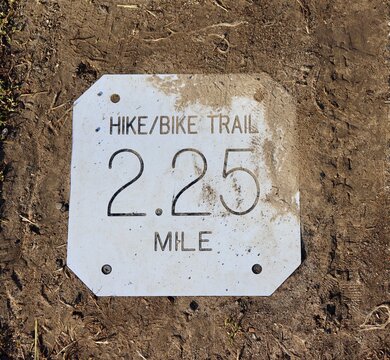 A close view of the metal distance sign plate.