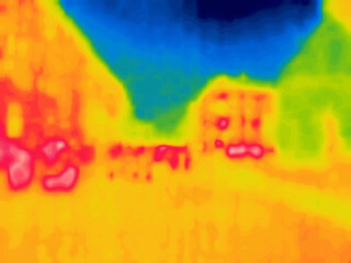 Street on a hot day and vehicles, hot asphalt, hot walls. Image from thermal imager device.