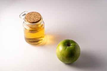 Fototapeta na wymiar apple vinegar in a jar on white