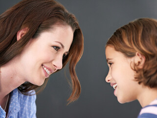 Mommy, girl and profile in studio for family, smile and security in love on gray background. Daughter, mother and happy together for trust or support, care and comfort in connection for bonding