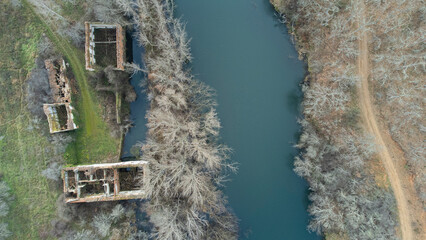 esla river from drone in winter morning next to road and ruined house