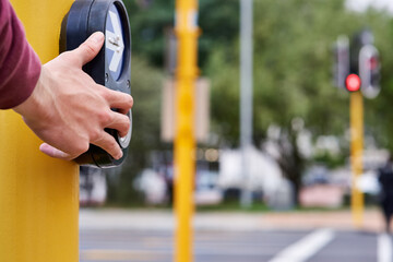 Hand, person and button at pedestrian crossing or traffic light for morning commute, safety or...