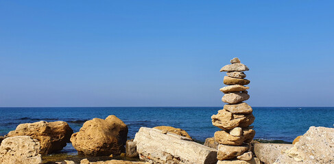 Pyramid of stones on the beach. The concept of harmony and relaxing . - 786304217