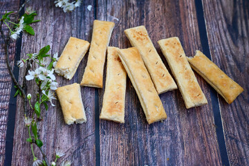 Sfogliatine, an Italian puff pastry with glaze on a plate on  wooden background