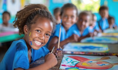 Cheerful african american primary school girl smiling with toothy smile at camera in painting class classroom at school - Powered by Adobe