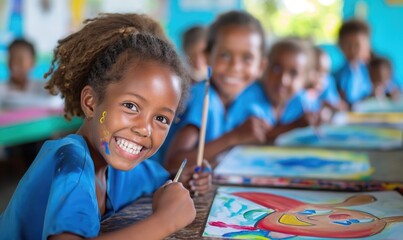 Cheerful african american primary school girl smiling with toothy smile at camera in painting class classroom at school