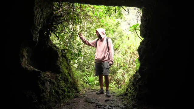 A man in a cave in the Laurisilva forest of Los tilos de Moya, Gran Canaria