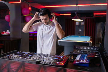 Smiling DJ Mixing Beats at Club Party