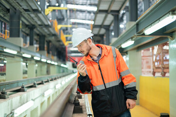 Railway maintenance engineers check readiness in the locomotive repair shop.