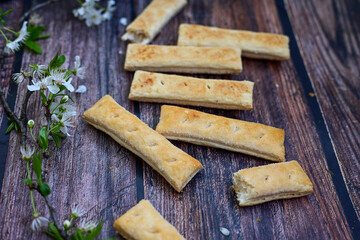 Sfogliatine, an Italian puff pastry with glaze on a plate on  wooden background