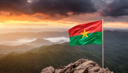 The Flag of Burkina Faso On The Mountain. - obrazy, fototapety, plakaty