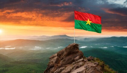 The Flag of Burkina Faso On The Mountain. - obrazy, fototapety, plakaty