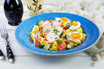 Healthy chicken salad. Fresh salad with avocado, tomato, chicken and herbs