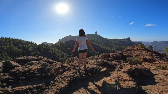 A woman hiker at a viewpoint of Roque Nublo in Gran Canaria, Canary Islands