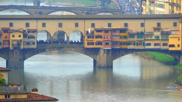 Ponte Vecchio (Old Bridge) is medieval stone closed-spandrel segmental arch bridge over Arno River, in Florence, Italy, noted for still having shops built along it, as was once common.