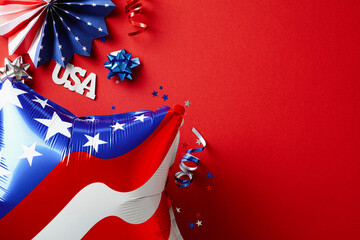 American flag balloons and decorations on red background. 4th of July, US National holiday celebration concept.