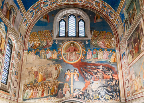 View of religious fresco in ruins decorating large wall inside medieval catholic church in Italy