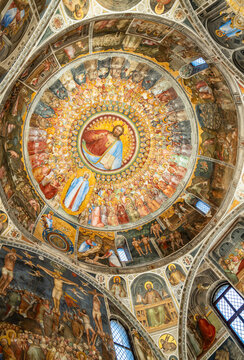 View of medieval frescos decorating the dome ceiling of catholic cathedral in Italy