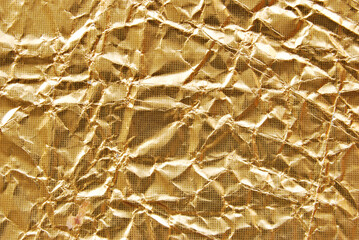 A sheet of golden metallic wrinkled foil as background