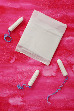 Women's menstrual pad and tampons on pink