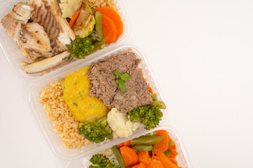 Healthy vegetables and meat packed lunch box meal in front top aerial view clean white background